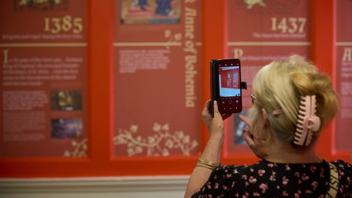 Visitors looking at the timeline in the Orange Room